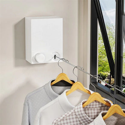 Retractable wall-mounted clothesline with stainless-steel drying rope for indoor and outdoor laundry drying.