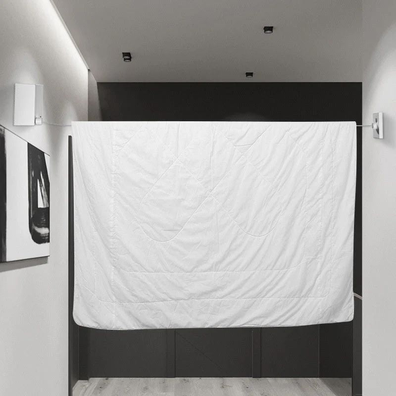 Retractable wall-mounted clothesline with stainless-steel drying rope for indoor and outdoor laundry drying.