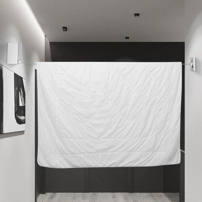 Retractable wall-mounted clothesline with stainless-steel drying rope for indoor and outdoor laundry drying.